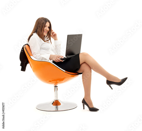 Zdjęcie: businesswoman with laptop in orange chair #2 businesswoman with laptop in orange chair #2