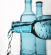 sparkling water pouring from blue bottle