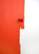 red paint roller by wall