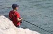boy fishing in the sea