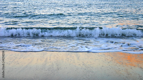 Wave splashing on the wet sand Wave splashing on the wet sand