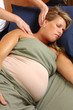 Massaging Shoulder of Pregnant Woman at Wellness Center