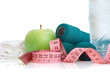 Dumbells, apple and measuring tape