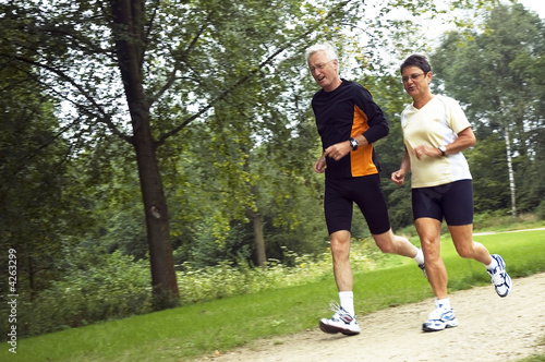 Photo: Senior Couple Running In The Woods Senior Couple Running In The Woods