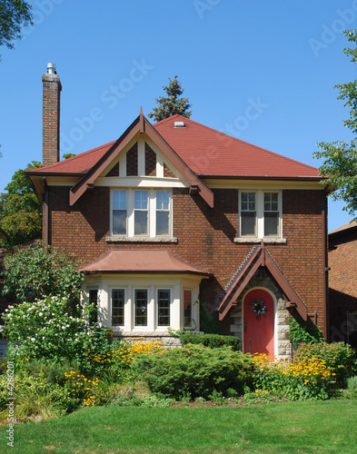 Small red brick two storey house 