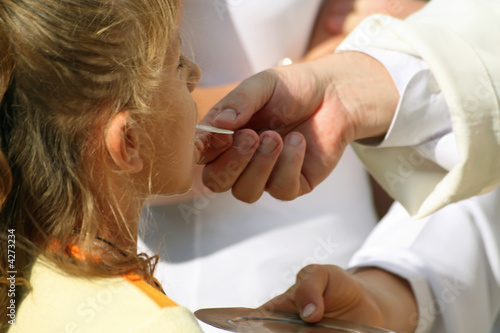 Photo: Priest giving the Holy Sacrament Priest giving the Holy Sacrament