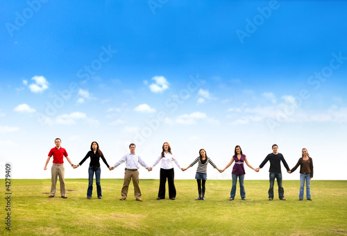 Friends holding hands outdoors