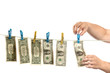 Hands and dollars on clothesline