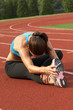 Woman in Sports Bra Leaning and Stretching Leg and Hamstring