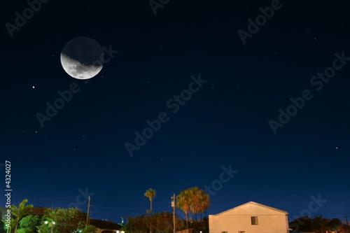 Photo: moon over city moon over city