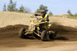 Photo: Teenager on a yellow quad bike sliding Teenager on a yellow quad bike sliding