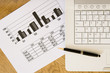 Photo: Laptop keyboard, pen and figures Laptop keyboard, pen and figures