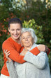 Young woman hugging her grandmother