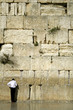 man praying next to the wailing wall, jerusalem,israel