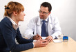 Foto: Doctor and young woman patient talking to each other. Doctor and young woman patient talking to each other.