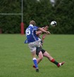 Fullback on a rugby team has his kick charged down.