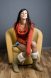 Photo: Full length view of teenage girl sitting in yellow armchair. Full length view of teenage girl sitting in yellow armchair.