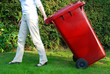 Person pulling wheelie bin