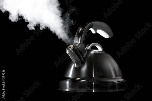 Photo: Tea kettle with boiling water on black background Tea kettle with boiling water on black background