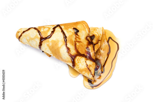 Pancake with honey covered with chocolate syrup