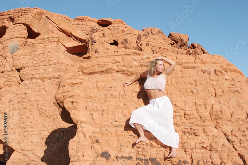 Sexy mature woman on red rocks