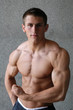 Young Muscular Man Flexing His Biceps