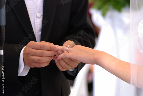 He puts the wedding ring on her
