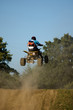 Teenager on a yellow quad bike jumping