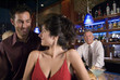 a young couple gets close to each other at a bar
