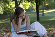 Woman reading a book in the park