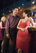 a young couple chats while hanging out at a bar