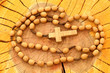 Wooden rosary on wood