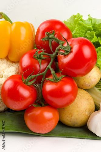 Photo: Cluster of tomatoes on vegetable background Cluster of tomatoes on vegetable background
