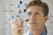 Scientist examining a DNA molecule