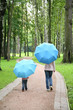 mother with the child under the umbrellas in the park
