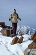 Yong woman travels in winter mountain