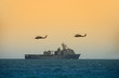 Navy battleship with hovering helicopters