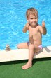 child sitting on the pool side