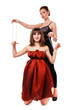 Two beautiful girls acting as wire-puller and marionette