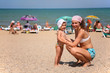 happy mom and daughter on beach