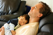 Photo: Father sleeping on chair with his baby boy on chest Father sleeping on chair with his baby boy on chest