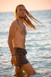 A man with long hear in the sea