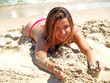 attractive woman playing wtih sand