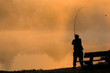 Fishing in foggy morning at sunrise