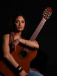 Beautiful latino rock chick with an acoustic guitar