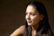 The beautiful brunette with long hair on a brown background The beautiful brunette with long hair on a brown background