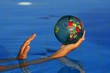 Woman catching and reaching the world