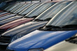 reflecting windscreens from a row of cars