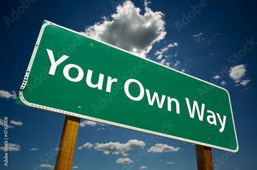 Photo: "Your Own Way" Road Sign with dramatic blue sky and clouds. "Your Own Way" Road Sign with dramatic blue sky and clouds.