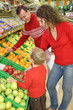 parents with son in shop